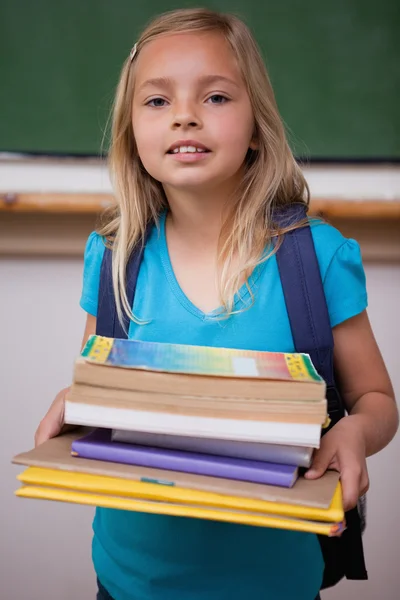 Portrait of a happy schoolgirl holding her books — Stock Photo, Image