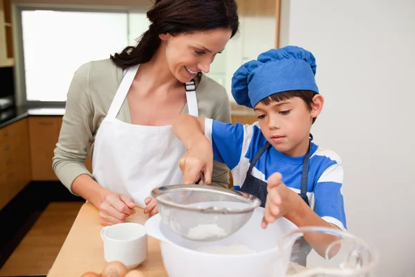 Son and mother preparing dough — Stock Photo, Image