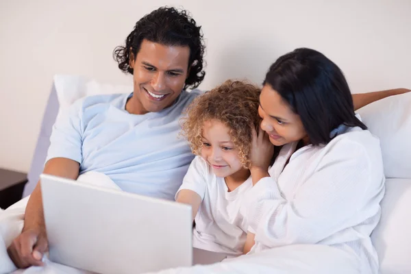 Family in the bedroom surfing the internet — Stock Photo, Image