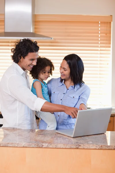 Family using notebook in the kitchen together — Stock Photo, Image