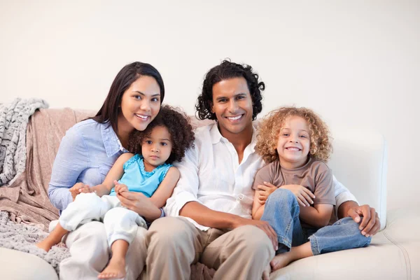 stock image Cheerful family sitting on the sofa together