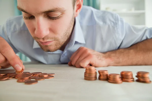 Businessman counting coins Royalty Free Stock Images