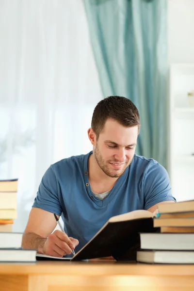 Smiling student reviewing his subject material Royalty Free Stock Images