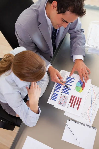 Above view of business working with statistics — Stock Photo, Image