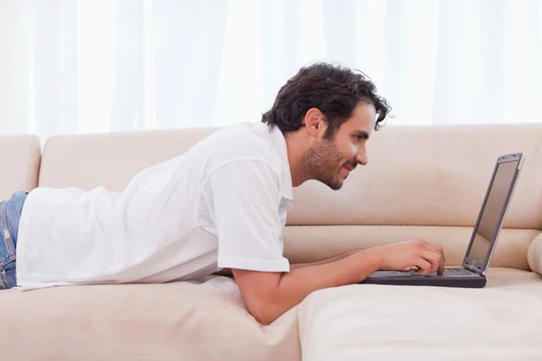 Handsome man using a laptop — Stock Photo, Image