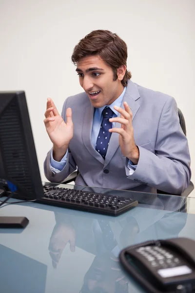 Businessman getting confused by his computer Royalty Free Stock Images