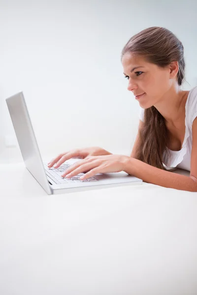Woman typing on her laptop Stock Image