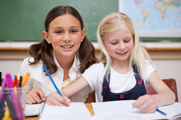 Pupils working together on an assignment Stock Photo