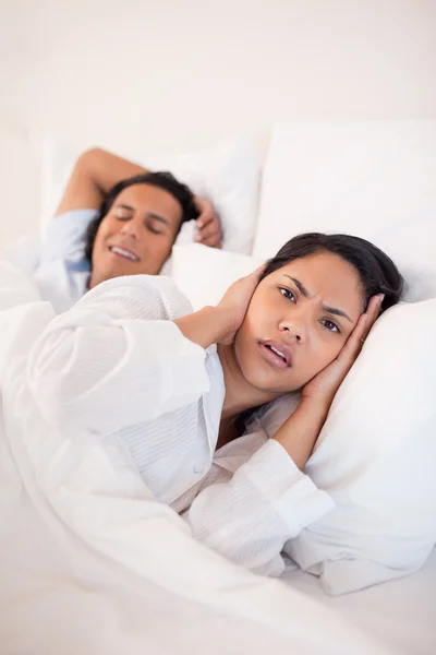 Woman being annoyed by snoring boyfriend Royalty Free Stock Images