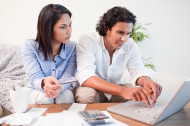 Couple checking their bank accounts online clipart