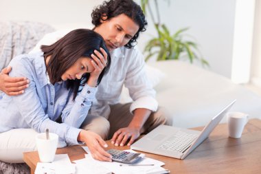 Side view of couple having a hard time paying their bills clipart