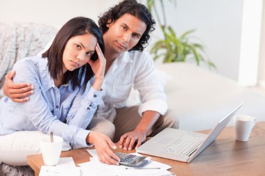 Couple having a hard time paying their bills clipart