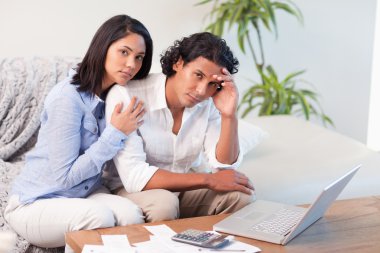 Frustrated couple underestimated their spending clipart