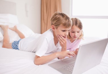 Children using a laptop clipart