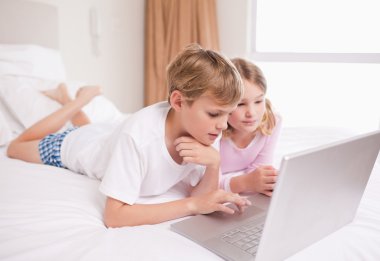 Children using a notebook clipart