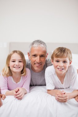 Portrait of siblings and their father posing clipart