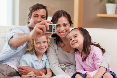 Father taking a picture of his family clipart