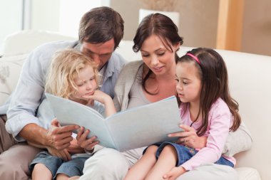 Family looking at a photo album clipart