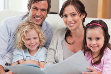 Close up of a family looking at a photo album clipart