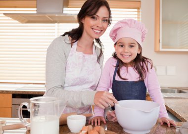 Mother baking with her daughter clipart