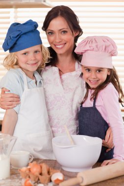 Portrait of a mother and her children baking clipart