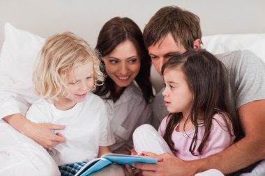 Family reading a book clipart