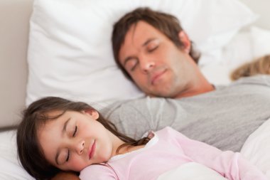 Calm father sleeping with his daughter clipart