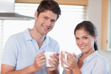 Happy couple drinking coffee clipart