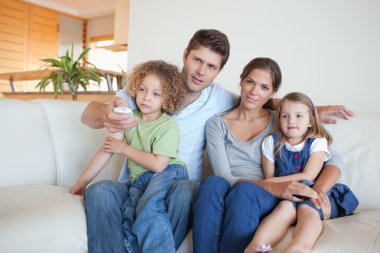 Family watching TV together clipart