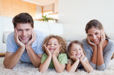 Family lying on a carpet clipart