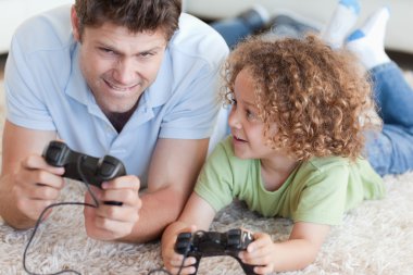 Boy and his father playing video games clipart