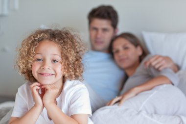 Boy sitting on his parents's bed clipart