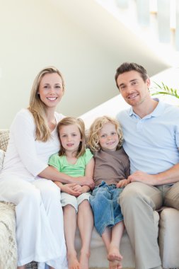 Family sitting on the couch clipart