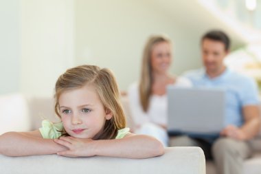 Thoughtful girl with parents behind her clipart