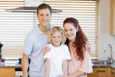 Family standing together in the kitchen clipart