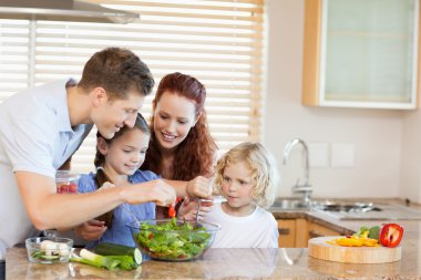 Family preparing salad together clipart