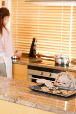 Sneaky boy stealing cookies clipart