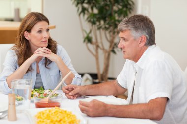 Family sitting at dinner table clipart