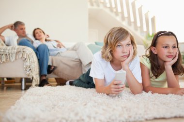 Siblings bored by tv program clipart