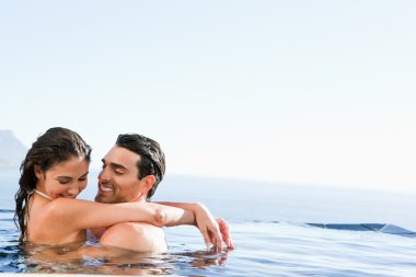 Couple hugging in the pool clipart