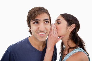 Charming woman whispering something to her fiance clipart