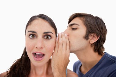 Man whispering something shocking to his fiance clipart
