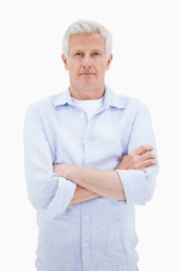 Portrait of a mature man with the arms crossed clipart