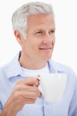 Portrait of a mature man drinking tea clipart