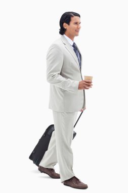 Portrait of a businessman with a takeaway coffee and a suitcase clipart