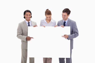 Businessteam pointing at blank sign in their hands clipart