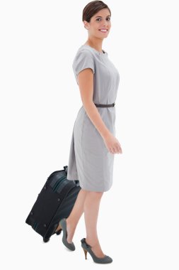 Side view of smiling woman with wheely bag clipart