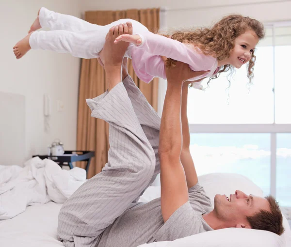 Father playing plane with his daughter — Stock Photo, Image