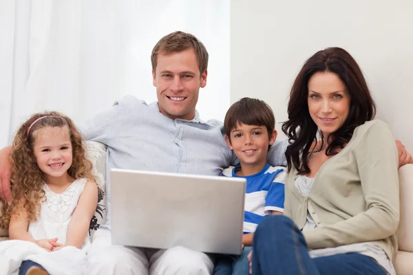 Familie surft gemeinsam im Wohnzimmer im Internet — Stockfoto