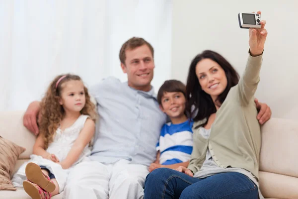 Mother taking a family picture on the couch — Stock Photo, Image